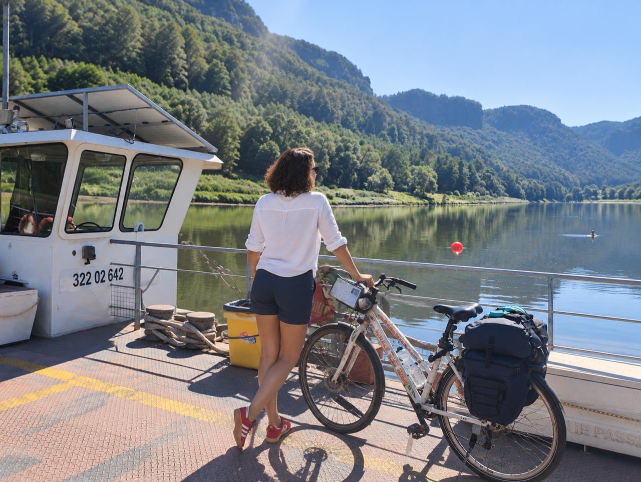 Bernardette M. with a touring bicycle on a river ferry.
