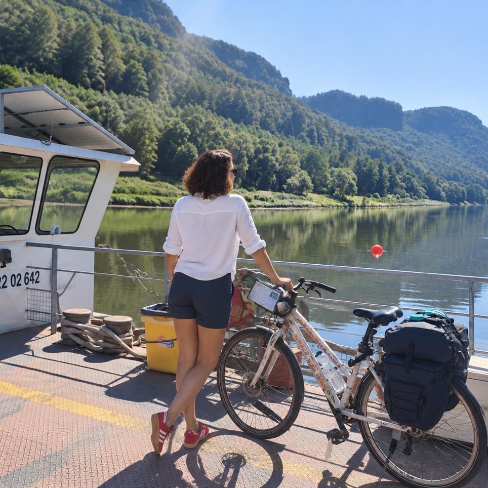 Bernardette M. with a touring bicycle on a river ferry.